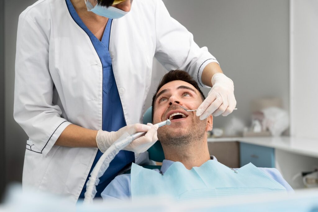 Dental Surgeons with Male Patient