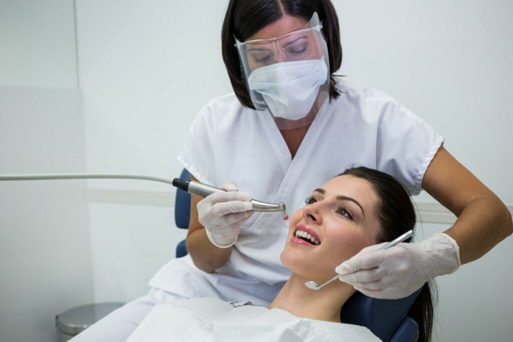 Dentist Treating Women with Teeth Problem