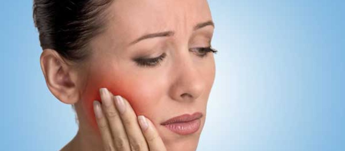 woman with toothache - biologic dentistry